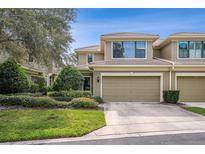 Charming two-story townhouse with a well-manicured lawn and a two-car garage at 13215 San Blas Loop, Largo, FL 33774