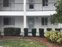 Condo building exterior with entrance and landscaping at 2060 Marilyn St # 103, Clearwater, FL 33765