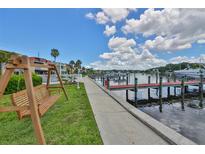 Beautiful waterfront view featuring a boat dock and swing, perfect for enjoying the serene waterside ambiance at 2424 W Tampa Bay Blvd # B201, Tampa, FL 33607