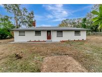 Newly renovated single story home with a modern exterior and landscaped yard at 40242 Sunburst Dr, Dade City, FL 33525