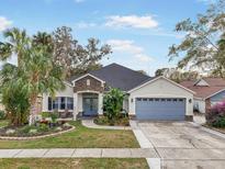 Charming one-story home with landscaped yard and attached garage at 4544 Oak River Cir, Valrico, FL 33596