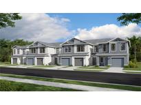 Two-story townhouses with gray and white siding, two-car garages, and landscaping at 14110 Lilac Sky Ter, Bradenton, FL 34211