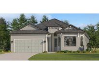 Single-story home with gray siding, two-car garage, and a neatly landscaped lawn at 19171 Cherrystone Way, Lakewood Ranch, FL 34202