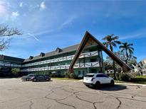 Exterior of a light teal condominium building with a unique architectural design at 2042 Australia W Way # 78, Clearwater, FL 33763