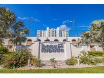 Beaumonde condominium building, featuring a beautiful entryway and landscaping at 4950 Gulf Blvd # 409, St Pete Beach, FL 33706