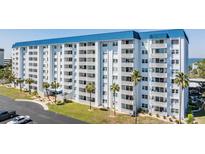 Condo building with palm trees and ocean views at 7 Elgin Pl # 401, Dunedin, FL 34698