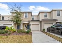 Two-story townhome with attached garage and landscaping at 7014 Summer Holly Pl, Riverview, FL 33578
