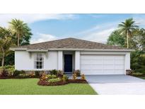 One-story home with a two-car garage and landscaped lawn at 7812 Wheat Stone Dr, Zephyrhills, FL 33540