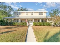 Two-story house with a wraparound porch and landscaped yard at 7312 7Th Nw Ave, Bradenton, FL 34209