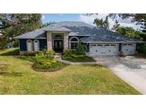 Beautiful two-story home with a three-car garage and landscaped yard at 10745 Bardes Ct, Seminole, FL 33777