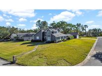 Two-story house with a large backyard and detached garage at 11201 Lake Sassa Dr, Thonotosassa, FL 33592