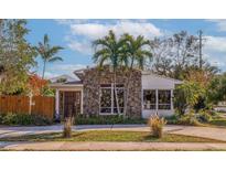 Stone and stucco house with a landscaped yard and driveway at 400 22Nd Ne Ave, St Petersburg, FL 33704