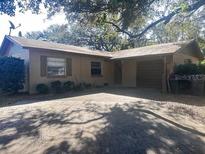 Tan single-story house with attached garage and driveway at 513 Noble Ave, Brandon, FL 33510