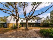 Large two-story home with stone accents and a spacious front yard at 18029 Lake Reflections Blvd, Lutz, FL 33558