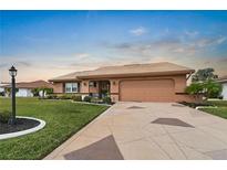 Beautiful single-story home with a large driveway and well-manicured lawn at 1809 Wolf Laurel Dr, Sun City Center, FL 33573