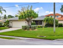 Single-story home with attached garage and lush landscaping at 3560 Tripoli Blvd, Punta Gorda, FL 33950