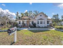 Charming light-yellow house with a well-maintained lawn and stone accents at 37620 Howard Ave, Dade City, FL 33525