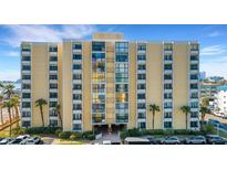 Exterior of a multi-story building with parking and landscaping at 800 S Gulfview Blvd # 101, Clearwater Beach, FL 33767