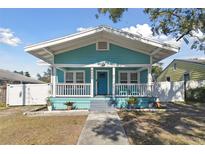 Charming bungalow with a teal exterior, white trim, and a welcoming front porch at 111 W Ida St, Tampa, FL 33603