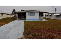 White single-wide mobile home with carport and small yard at 5341 Mary St, Zephyrhills, FL 33542