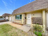 House exterior with white door and green bushes at 8330 Vendome N Blvd, Pinellas Park, FL 33781