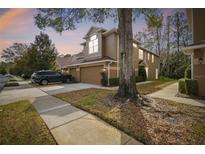 Two-story townhome with attached garage and landscaping at 18924 Duquesne Dr, Tampa, FL 33647