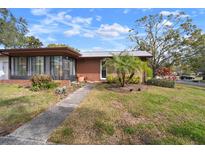 Brick ranch home with carport, mature landscaping, and a spacious yard at 2320 Shelly Dr # B, Palm Harbor, FL 34684