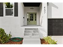 Modern home exterior with light gray steps and a sage green front door at 457 Dawson Ne Ave, St Petersburg, FL 33703