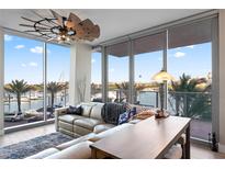 Living room with water views, comfortable seating, and a stylish wooden coffee table at 5120 Marina Way # 2208, Tampa, FL 33611