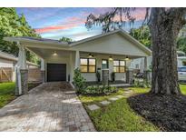 Charming craftsman home with a welcoming front porch and landscaped yard at 1210 E Mohawk Ave, Tampa, FL 33604