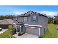 Beautiful two-story home featuring a spacious two-car garage and well-manicured front lawn at 13455 Jamaica Plank Loop, Riverview, FL 33579