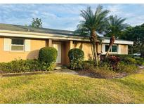 Cute condo with well-manicured landscaping and palm trees at 1510 Palmer Ct, Palm Harbor, FL 34685