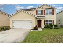 Two-story house with a large garage and landscaped lawn at 15737 High Bell Pl, Bradenton, FL 34212