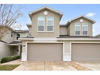 Two-story townhome with a two-car garage and neutral color scheme at 1950 Marlington Way, Clearwater, FL 33763