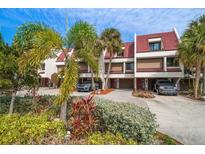 Attractive townhouses with red tile roofs, lush landscaping, and private parking at 224 Skiff Pt # 224, Clearwater Beach, FL 33767