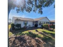 Home exterior showcasing a screened patio and backyard at 2241 Greenwich Dr # 68, Sun City Center, FL 33573