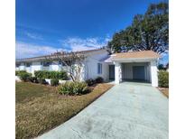 White single story home with carport and landscaped lawn at 2241 Greenwich Dr # 2241, Sun City Center, FL 33573