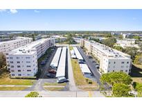 Aerial view of a condominium complex featuring two buildings, parking, and landscaping at 5705 80Th N St # 210, St Petersburg, FL 33709