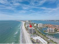 Aerial view of beachfront condo building with ocean and city views at 1660 Gulf Blvd # 304, Clearwater Beach, FL 33767