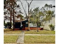 Charming single-story home with brick base and sidewalk leading to the front door at 1701 Shore Acres Ne Blvd, St Petersburg, FL 33703