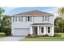 Two-story house with gray siding, a two-car garage, and landscaping at 2577 Chapel Oak Bnd, Wesley Chapel, FL 33543