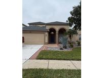 Two-story house with a two-car garage and landscaped front yard at 3830 Stornoway Dr, Land O Lakes, FL 34638