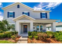 Two-story house with gray siding, blue shutters, and a front porch at 5027 Autumn Ridge Dr, Wesley Chapel, FL 33545