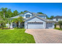 Two-story house with a large driveway and landscaped lawn at 5103 Ashcrest Ct, Tampa, FL 33647