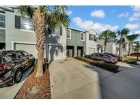 Two-story townhome with attached garage and landscaping at 8967 Indigo Trail Loop, Riverview, FL 33578