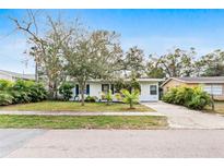 Cute bungalow with a landscaped lawn and driveway at 911 16Th Nw Ave, Largo, FL 33770