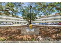 Exterior view of a two-story condo building with ample parking at 2284 Spanish Dr # 26, Clearwater, FL 33763