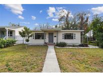 Cute bungalow style home with a landscaped lawn and walkway at 2934 3Rd S Ave, St Petersburg, FL 33712