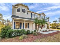 Two-story house with gray siding, blue shutters, and landscaping at 3870 155Th E Ave, Parrish, FL 34219