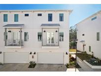 Modern three-story townhome with attached garage and balcony at 4722 Legacy Park Dr, Tampa, FL 33611